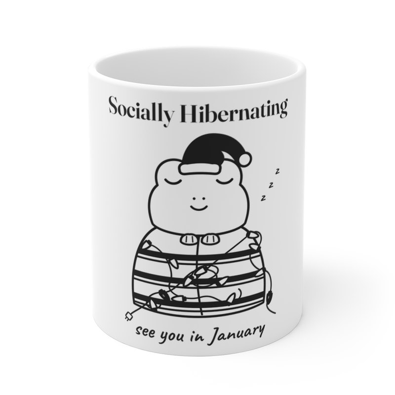 White mug printed with the Socially Hibernating Christmas frog in black and white