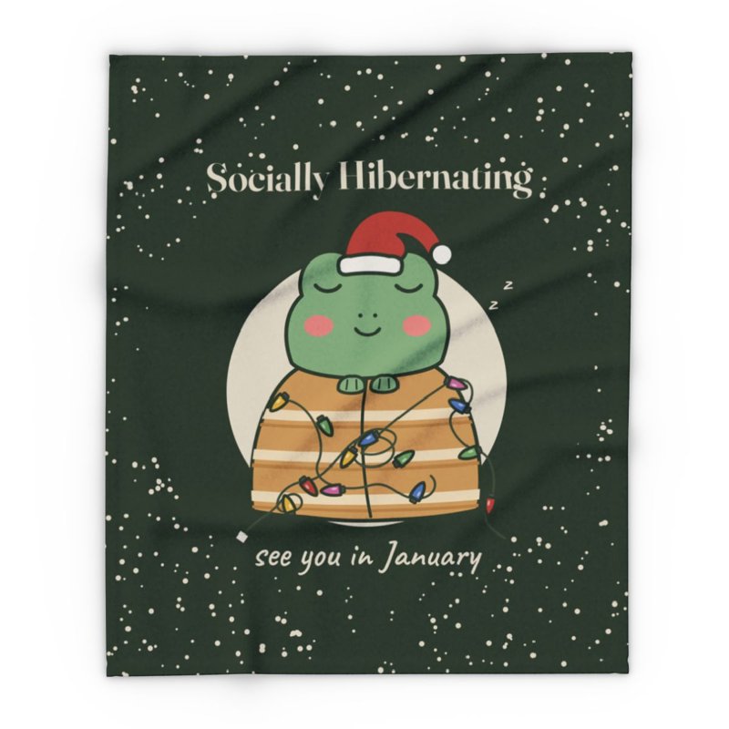 Dark green fleece throw printed with the Socially Hibernating Christmas frog and snow